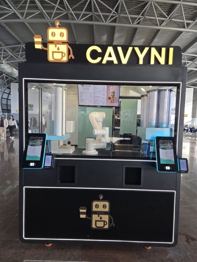 A robot arm preparing and selling coffee in an airport
